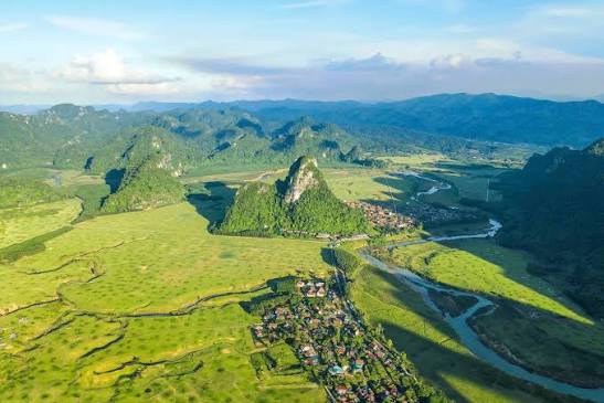 A green valley and limestone mountains at Tan Hoa tourism village