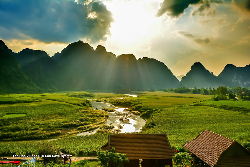 Tan Hoa valley with grassland, river and limestone mountains